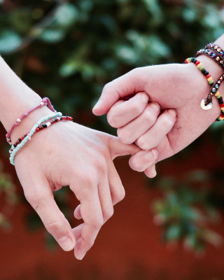 Nuoret pitelevät toisiaan kädestä.